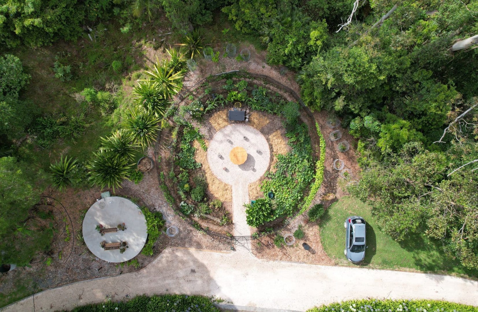 Aerial view of a circular garden with a seating area in the middle